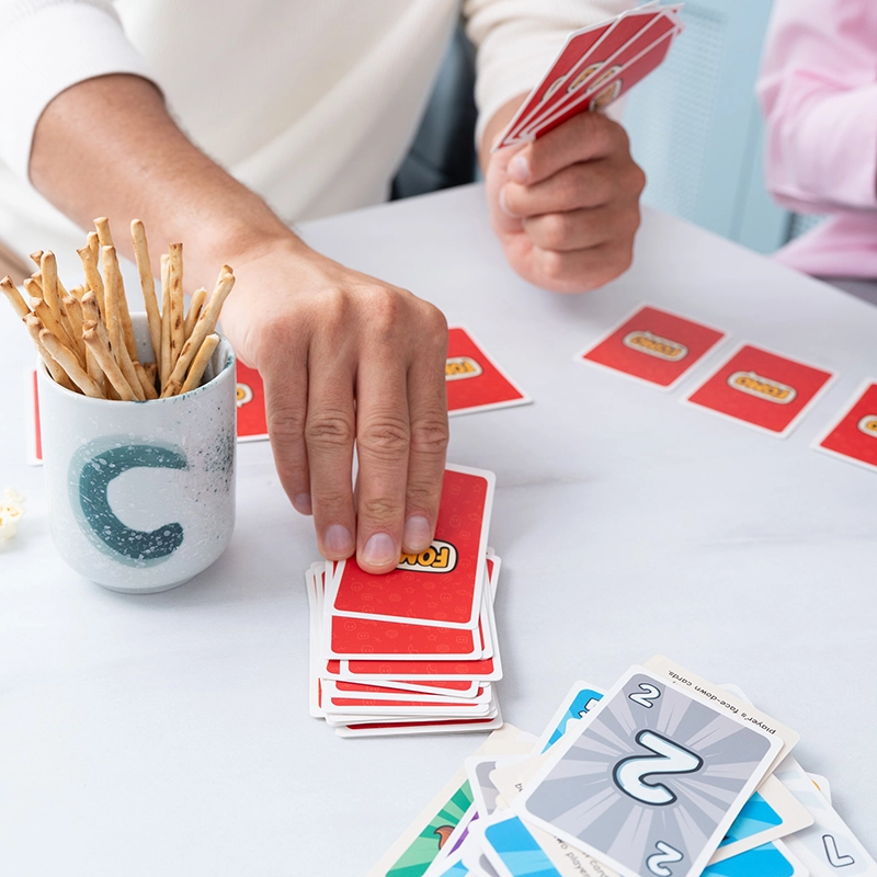 FOMO Card Game - Player Holding Action Cards